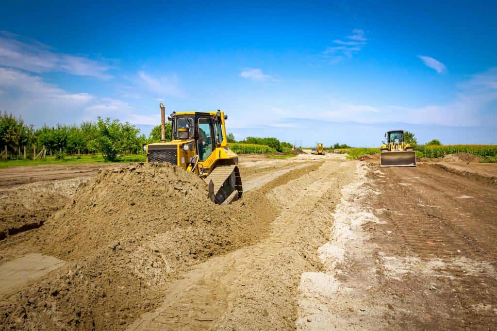 bulldozer machine is leveling construction sand