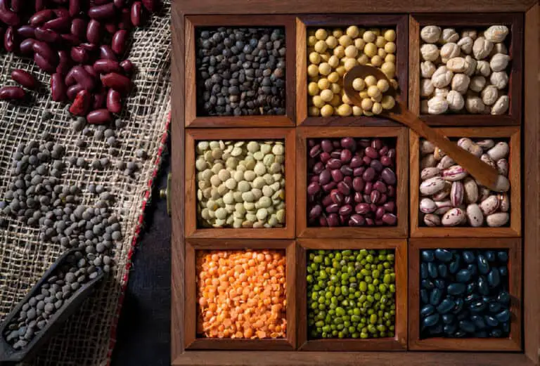 dried legumes assorted in a wooden box with soybean beans chickpeas lentils