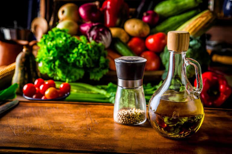 olive oil bottle and peppermint on a cutting board