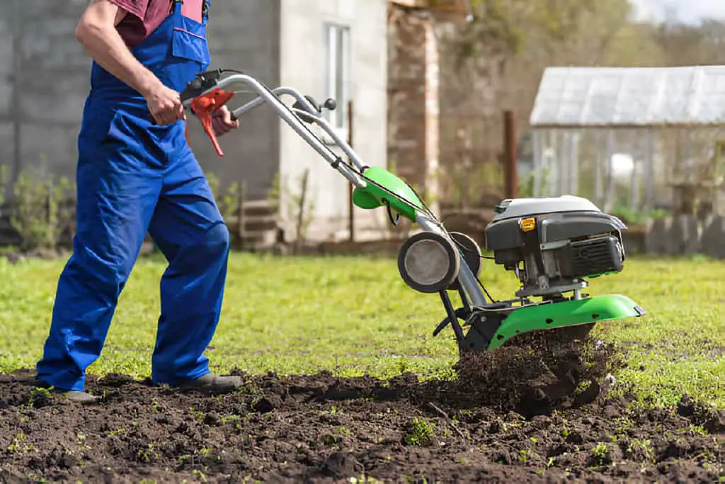 tills the land with a motorized cultivator or power tiller