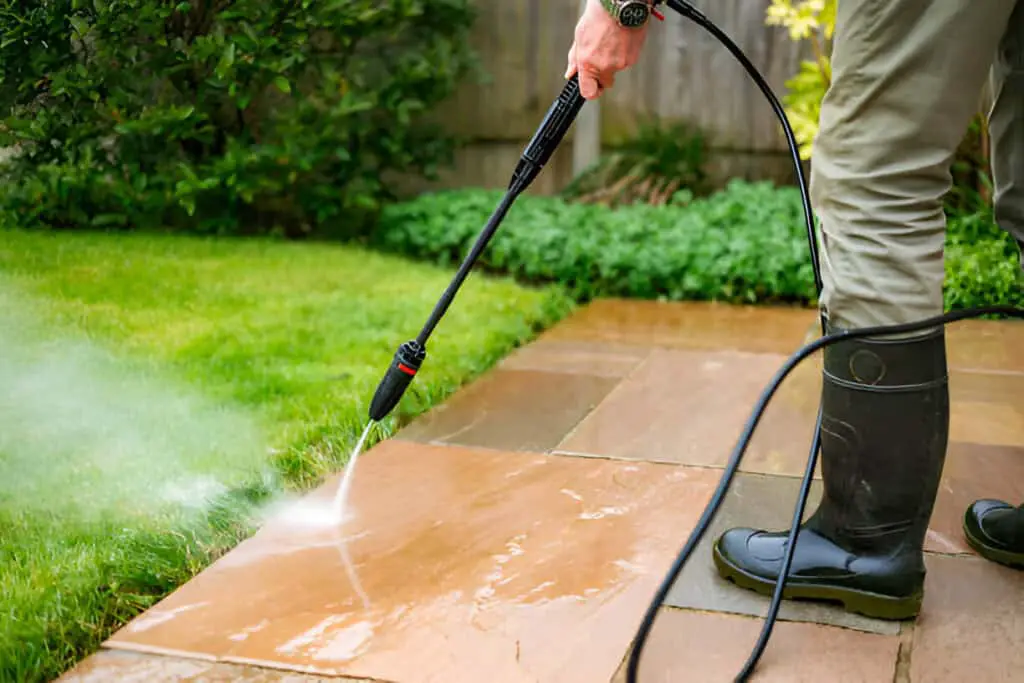 cleaning patio tiles using pressure washer